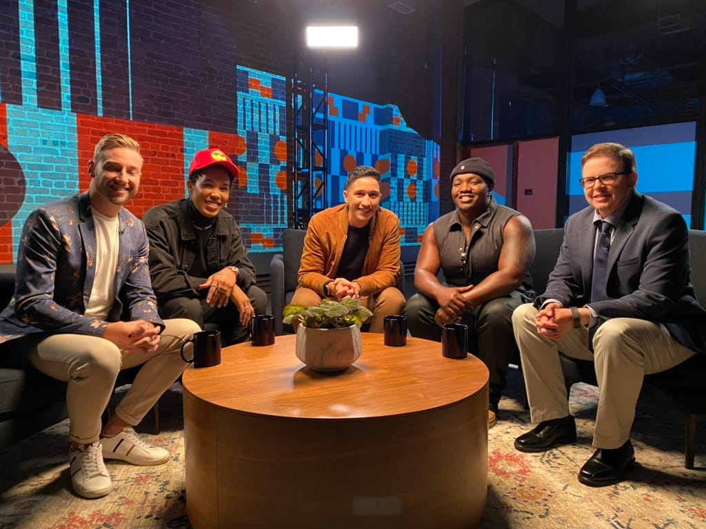 Arielle Duhaime-Ross and guests sit around a coffee table on the set of the TV show Queer sports